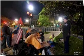 ADAPTers gather at night. A group of protestors gather at night outside.