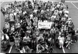 Black and white photo of a large group of protestors in wheelchairs