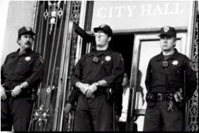 Black and white photo of three men in uniforms blocking the entrance to city hall