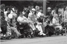 Black and white photo of a large group of protestors. Some in wheelchairs. Some standing.